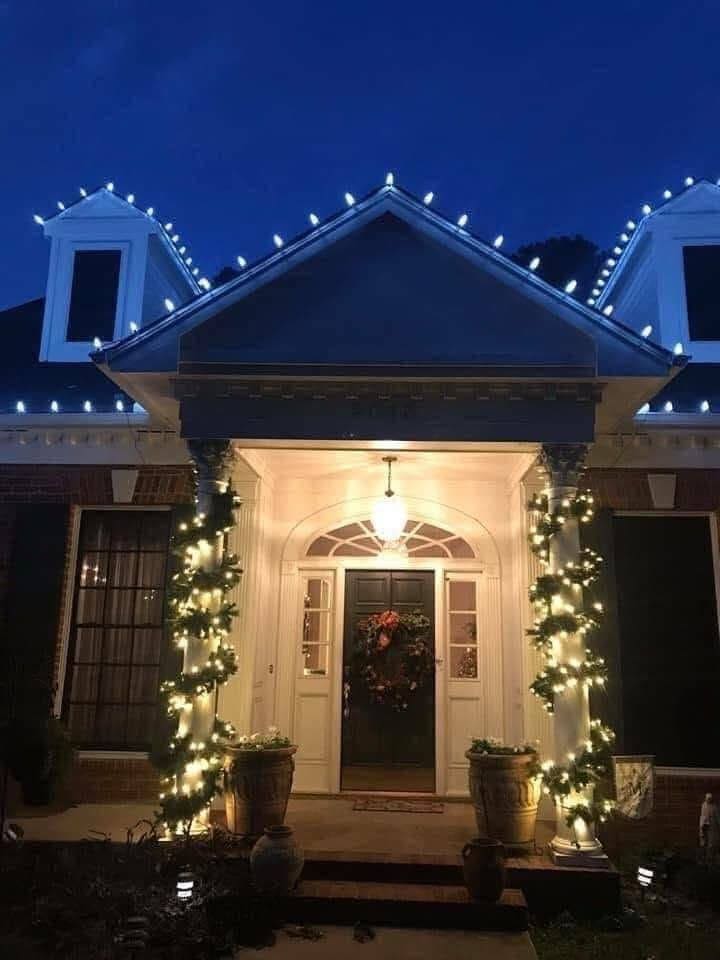 Wreath and wrapped columns lit at a front entrance